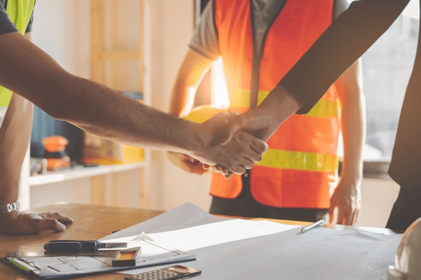 construction worker contractor client shaking 600nw 1801571473